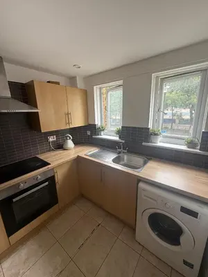 a kitchen with a sink and a washing machine at City Centre 2 Bed Apartment in Glasgow