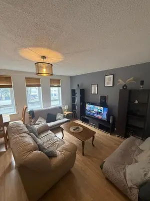 a living room with a couch and a tv at City Centre 2 Bed Apartment in Glasgow