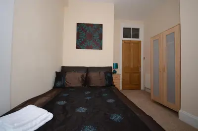 a bedroom with a large bed in a room at Townhead Apartments Glasgow Airport in Paisley
