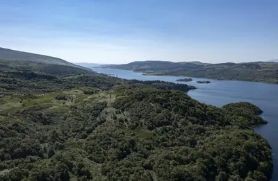 an aerial view of a lake in the hills at Dalnahua on 'The Secret Coast'