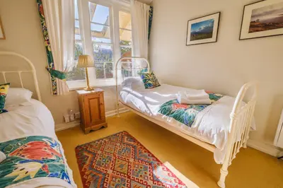 a room with two twin beds and a window at Castle Cottage No 2 in Acharn