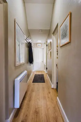a hallway of a home with wooden floors and walls at Castle Cottage No 2 in Acharn