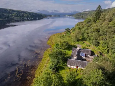 an aerial view of a house next to a river at Castle Cottage No 2 in Acharn