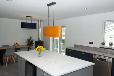 a kitchen with a vase of flowers on a counter at Private Home North of Dunblane in Braco
