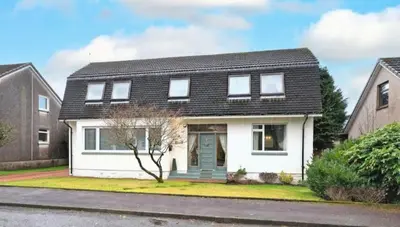 a white house with a black roof at Private Home North of Dunblane in Braco