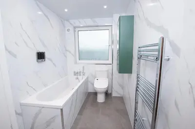 a white bathroom with a sink and a toilet at Private Home North of Dunblane in Braco