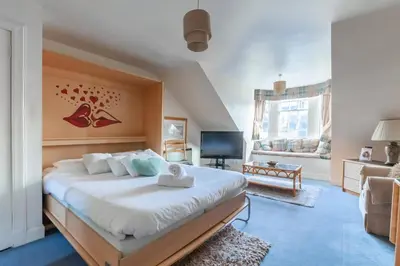 a bedroom with a large bed and a living room at Edinburgh City Retreat - EDINBURGH CITY CENTRE 3 min walk to Edinburgh castle in Edinburgh