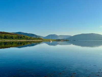 a large body of water with a boat in it at Hide-a-While in Rothesay