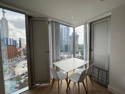 a white table and chairs in a room with a large window at victoria resedent in Moffat