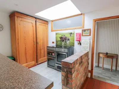 a kitchen with a stove and a counter top at Marshill Farm House in Lanark