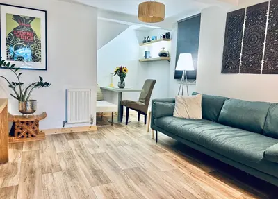 a living room with a couch and a table at Peaceful and Stylish Garden Flat Close to Transport and City Centre in Glasgow