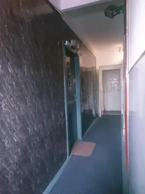an empty hallway with a stone wall and a door at The Puffins - Largs 2-Bedroom Ground Flat in Largs