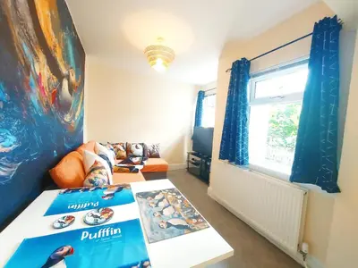 a living room with a couch and a table at The Puffins - Largs 2-Bedroom Ground Flat in Largs