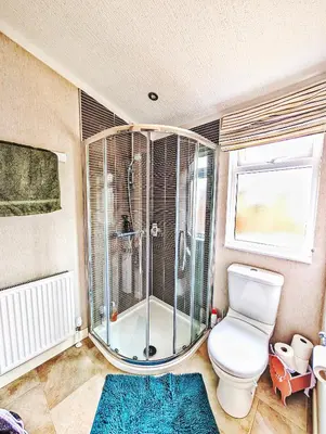a bathroom with a toilet and a glass shower at Lakeside Lodge - Lakeside Lodge Retreat - Golf & Spa, Gleneagles in Dunning