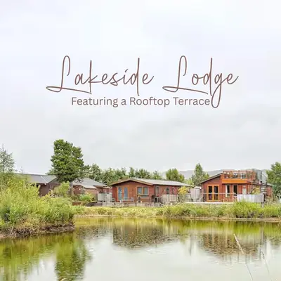 a view of a river with houses in the background at Lakeside Lodge Retreat, with Roof Deck - Golf & Spa, Gleneagles