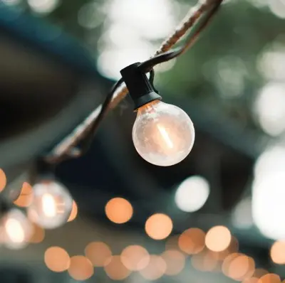 a light bulb hanging from a string with lights at Lakeside Lodge Retreat, with Roof Deck - Golf & Spa, Gleneagles