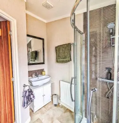 a bathroom with a glass shower and a sink at Lakeside Lodge Retreat, with Roof Deck - Golf & Spa, Gleneagles