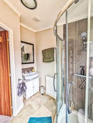a bathroom with a sink and a shower at Lakeside Lodge Retreat, with Roof Deck - Golf & Spa, Gleneagles