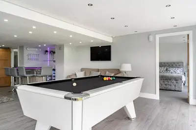 a living room with a pool table in it at 2 Bedroom Garden Flat in Bearsden