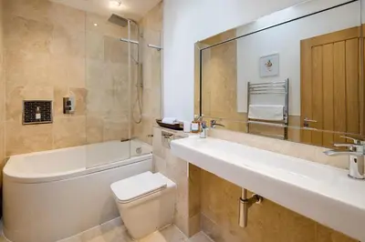 a bathroom with a sink and a tub and a toilet at Arrochar House in Tarbet