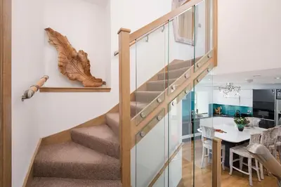 a staircase in a house with a table and a dining room at Arrochar House in Tarbet