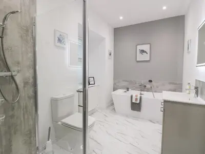 a bathroom with a shower and a toilet and a sink at Beach House in Stranraer