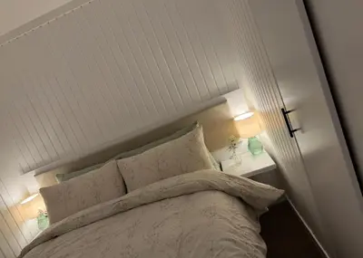 a bedroom with a white headboard and a bed with pillows at Hunters Quay - Hot Tub Lodge at Limecroft 6 in Hunters Quay