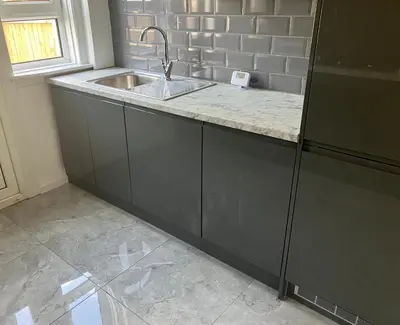 a kitchen with a sink and a counter at Modern and stylish 3 bedroom 2 bathroom west end house with Free WiFi and parking in Scotstoun West Station