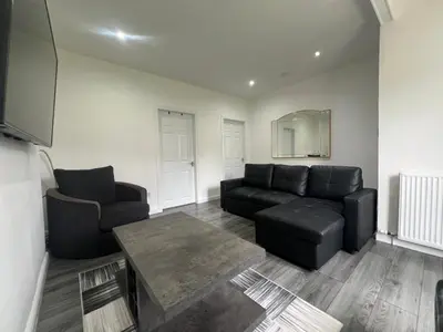a living room with a couch and a table at Modern and stylish 3 bedroom 2 bathroom west end house with Free WiFi and parking in Scotstoun West Station