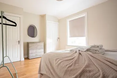 a bedroom with a bed and a window and a dresser at Pinkerton House in Dunfermline