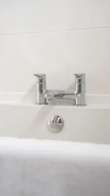 a bathroom sink with a silver faucet at Torbrex House in Cumbernauld