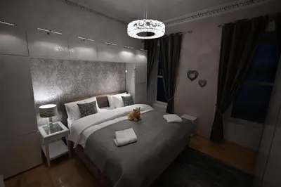 a bedroom with a large bed with a cat sitting on it at Harbour View in Rothesay