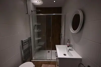 a bathroom with a shower and a toilet and a sink at Harbour View in Rothesay