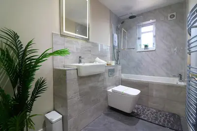 a bathroom with a sink and a toilet and a tub at Signature - Wellhead View in Lanark