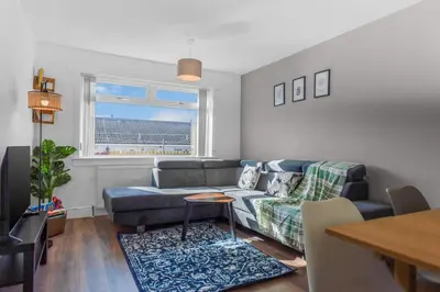 a living room with a couch and a table at Free Parking - Central - Sleeps 6 - 2 Bedrooms in Livingston