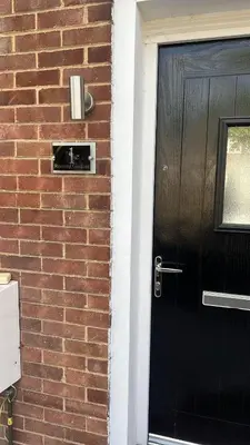 a black door to a brick house with a brick wall at Love Shack - Cozy 1BR Walthamstow in Moffat