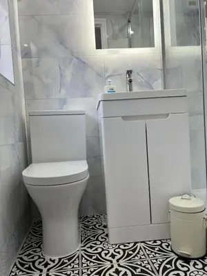 a white bathroom with a toilet and a sink at Love Shack - Cozy 1BR Walthamstow in Moffat