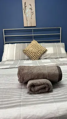 a bed with a towel laying on it at Love Shack - Cozy 1BR Walthamstow in Moffat