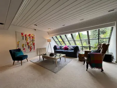 a living room with two couches and a large window at Edinburgh whole house let for DP World Tour, overlooking Bruntsfield Links 18th fairway, 30 min drive from The Renaissance Club in Edinburgh