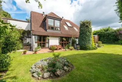 a house with a green yard with a garden at Edinburgh whole house let for DP World Tour, overlooking Bruntsfield Links 18th fairway, 30 min drive from The Renaissance Club in Edinburgh
