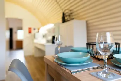 a table with bowls and glasses on top of it at Cultybraggan Hut 38 - Accessible in Comrie