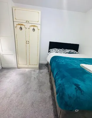 a bedroom with a bed and a dresser at Private Room in Glasgow City in Hillfoot