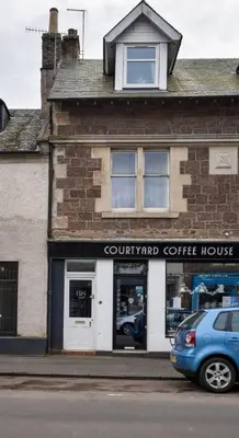 a car parked in front of a coffee house at Modern Comfort in Historic Callander in Stirling