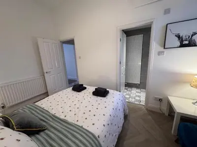a bedroom with a bed and a desk and a bed sidx sidx sidx at Balloch But & Ben in Balloch