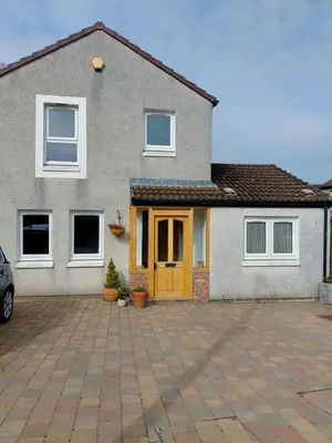 a house with a yellow door and a driveway at Comfortable room with en suite in Edinburgh