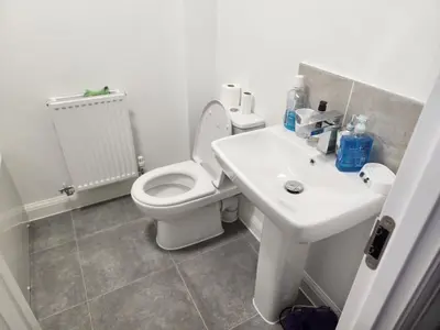 a bathroom with a white toilet and a sink at Edinburgh Road Nuneaton in Moffat
