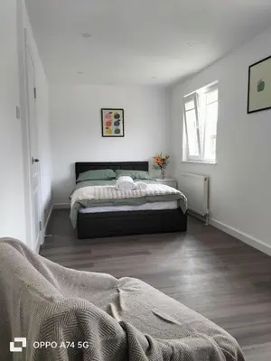 a bedroom with a bed in a white room at Quiet 5BR Ideal for Groups in Moffat