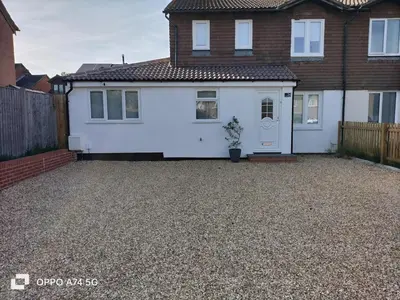 a white house with a driveway in front of it at Quiet 5BR Ideal for Groups in Moffat