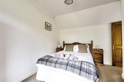 a bedroom with a bed with two towels on it at Argyll Farmhouse-Idyllic Setting-Sleeps10 in Dunoon