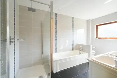a bathroom with a shower and a tub and a sink at Shawsmill, outside Hurlford in Hurlford
